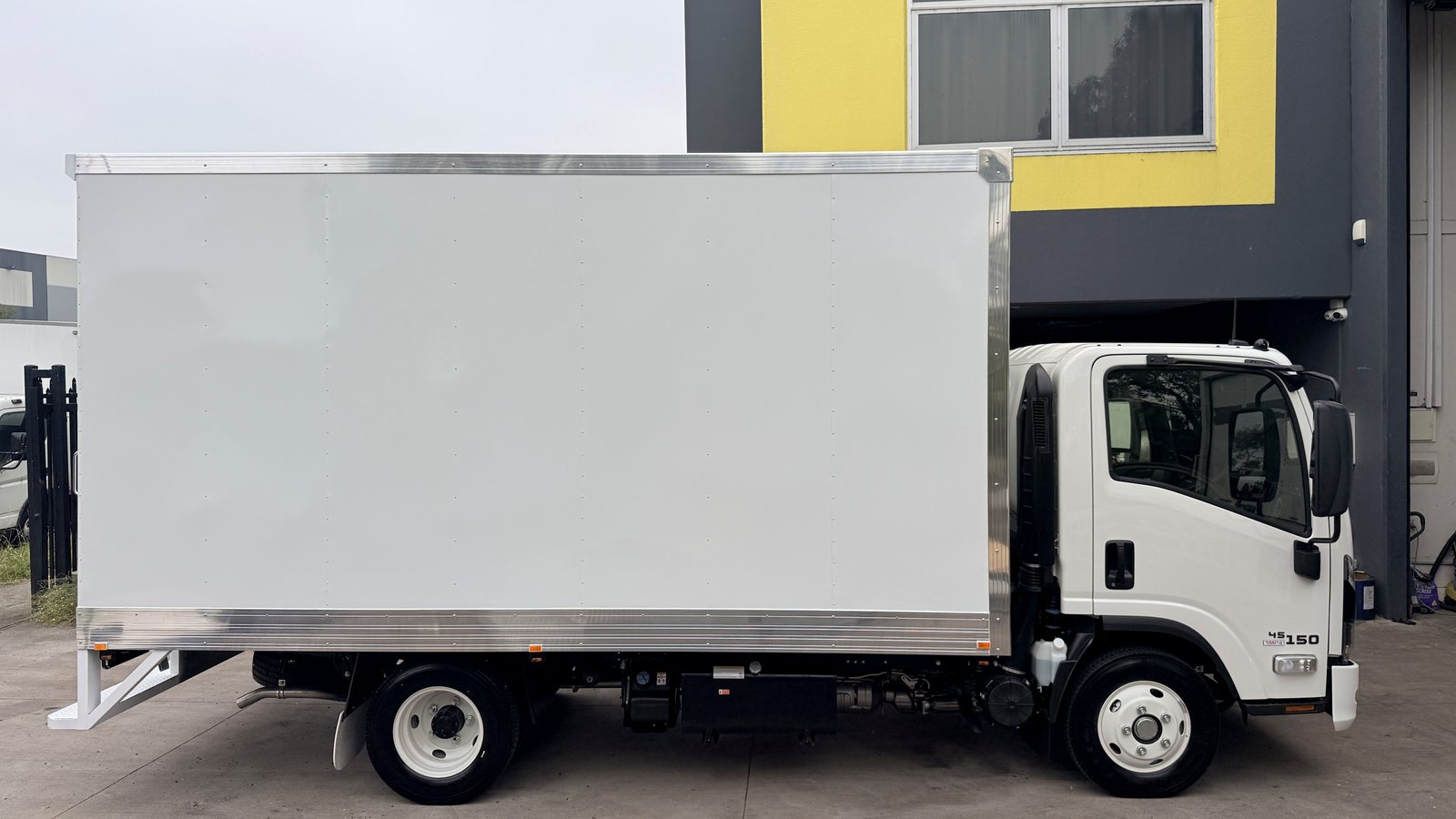 White Isuzu box truck side view